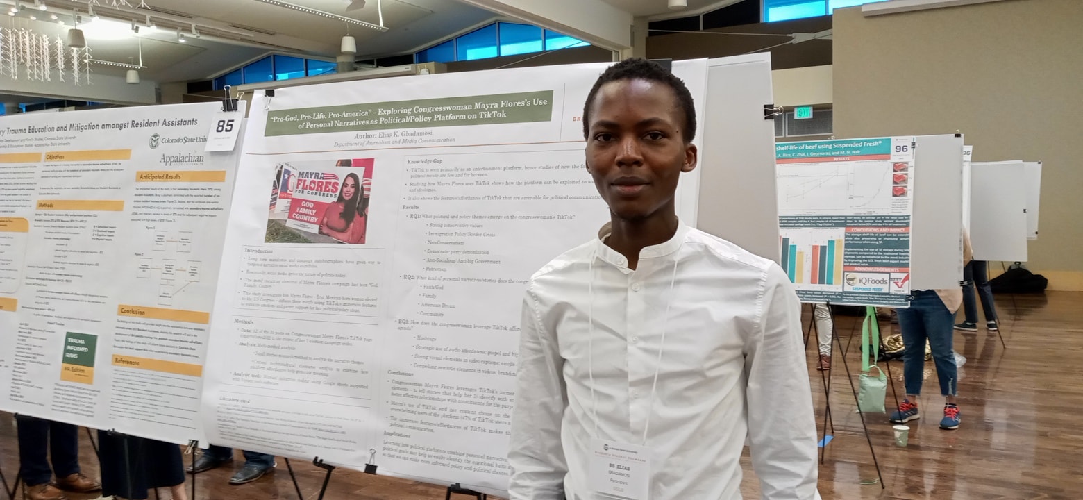 Elias Gbadamosi with his poster