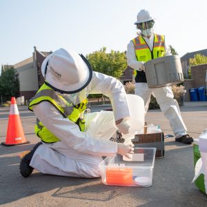 Workers testing wastewater