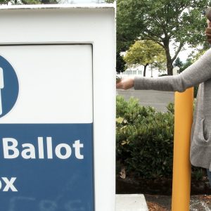 Woman dropping ballot in mailbox