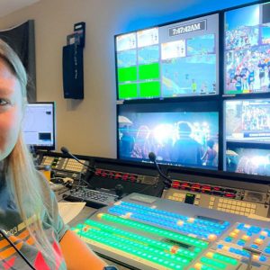 Megan Rakoczy in the control room for media coverage for the Bolder Boulder 10k, directing camera for broadcast