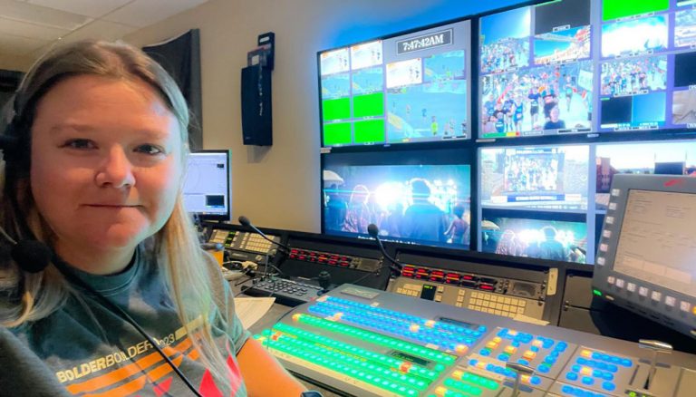 Megan Rakoczy in the control room for media coverage for the Bolder Boulder 10k, directing camera for broadcast